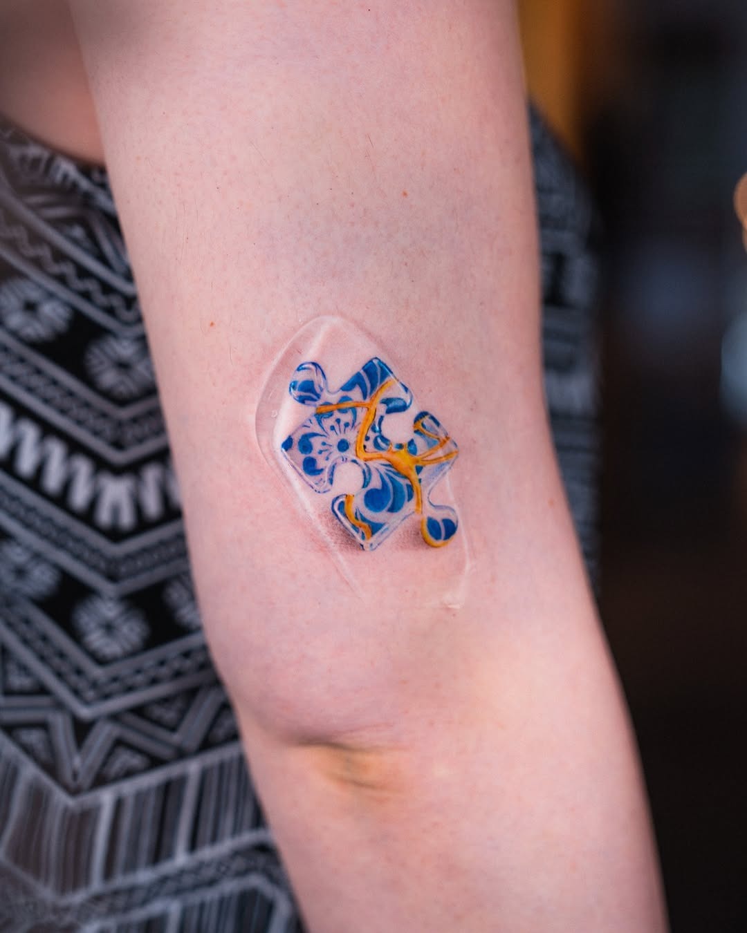 Vibrant puzzle tattoo with a fluid design Tattoo Design