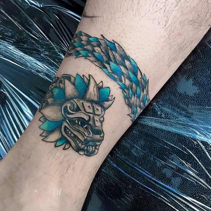 Dynamic Feathered Snake Along the Arm Tattoo Design