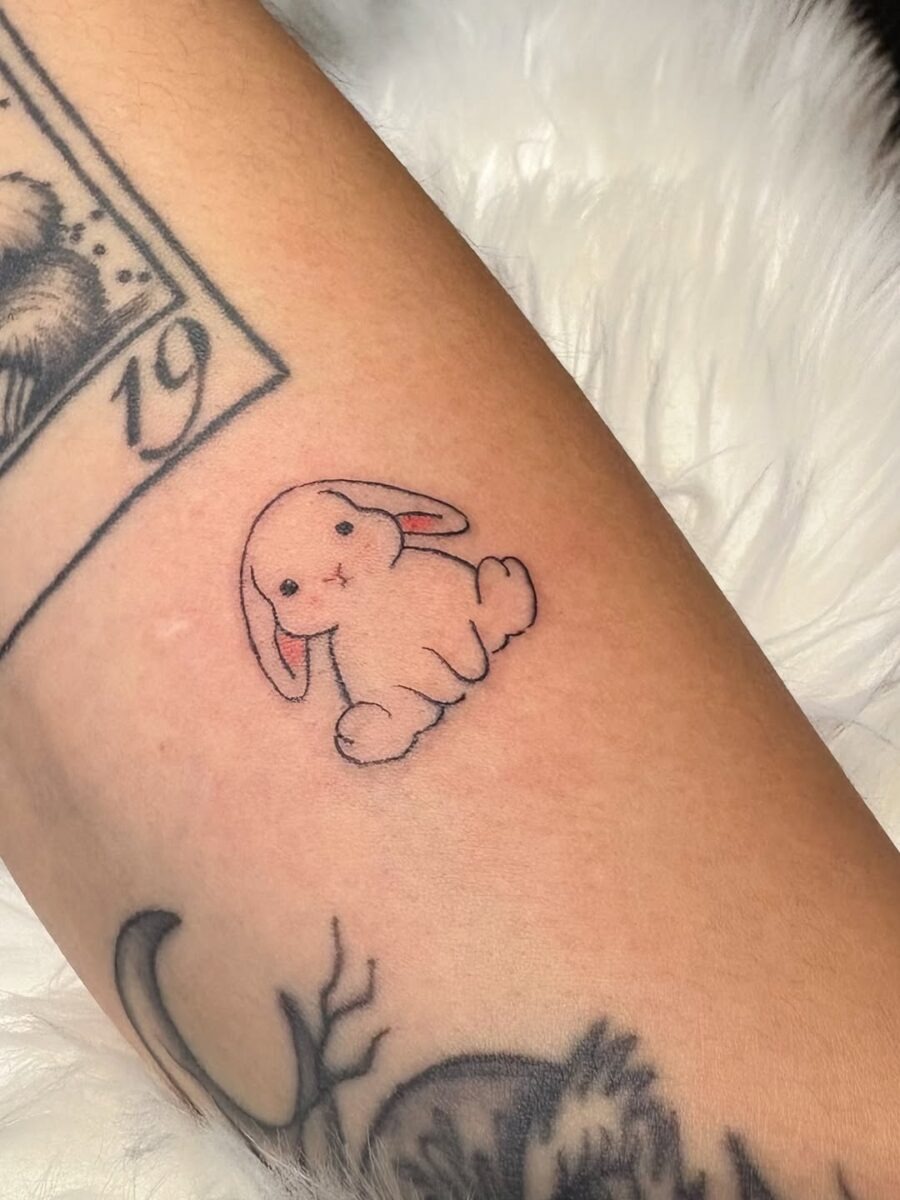Adorable pink rabbit tattoo adorns the skin Tattoo Design