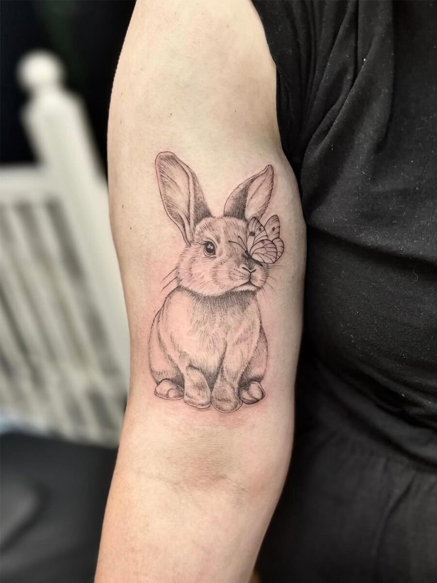 Adorable rabbit tattoo with butterfly detail Tattoo Design