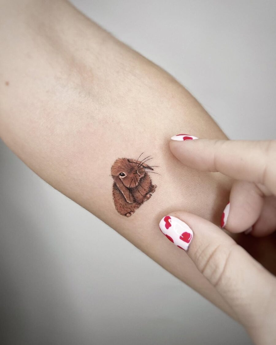 Charming brown rabbit tattoo on forearm Tattoo Design
