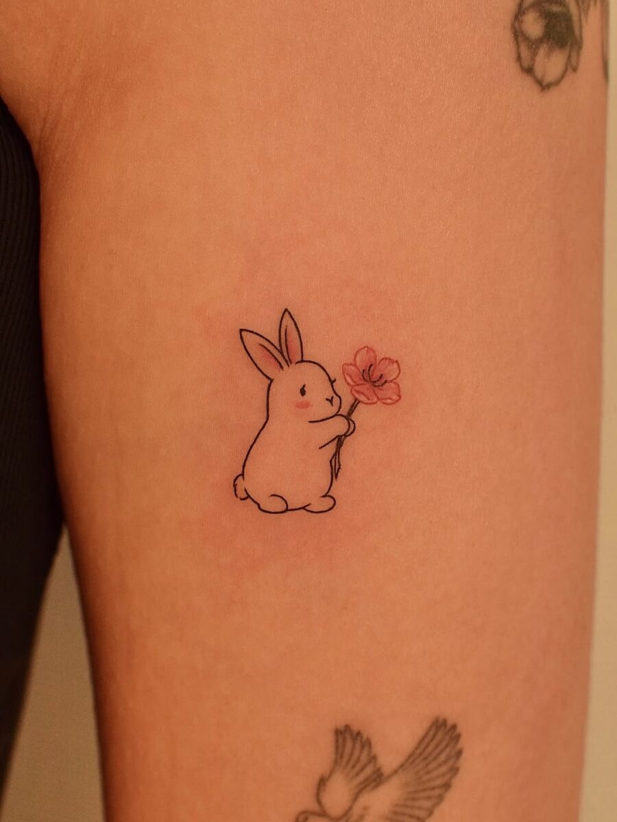 Charming Rabbit Holding a Flower Tattoo Design Tattoo Design