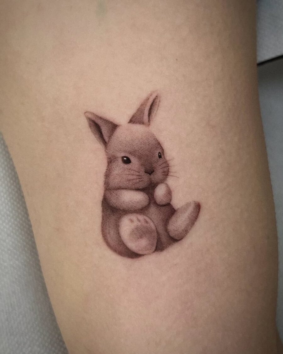 Charming rabbit tattoo showcasing adorable realism Tattoo Design