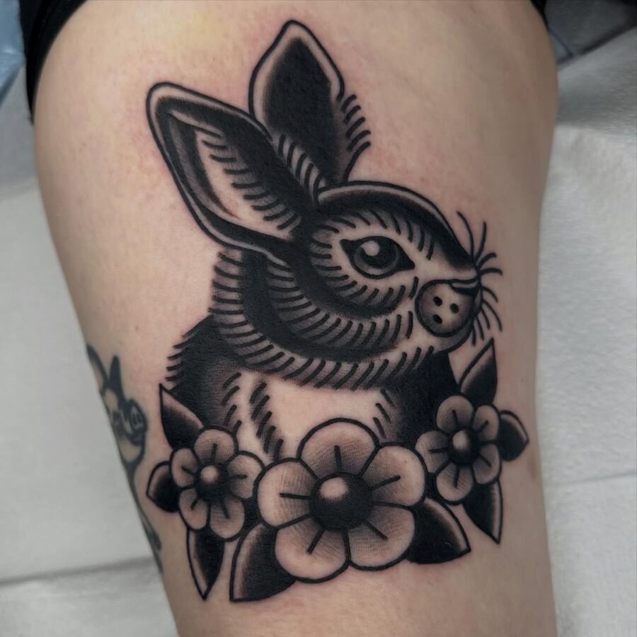 Charming rabbit tattoo surrounded by flowers Tattoo Design