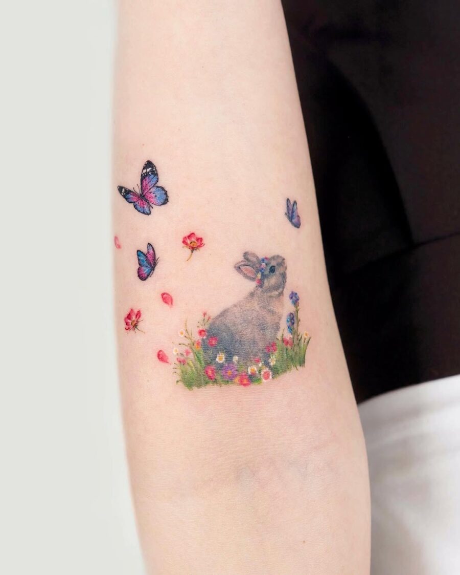 Charming rabbit tattoo surrounded by nature's beauty Tattoo Design