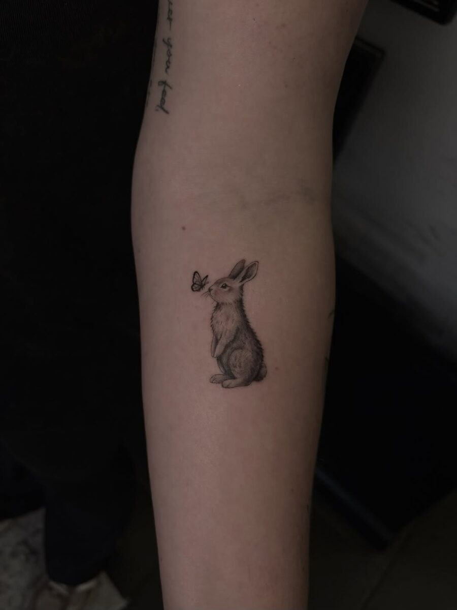 Charming rabbit tattoo with butterfly companion Tattoo Design