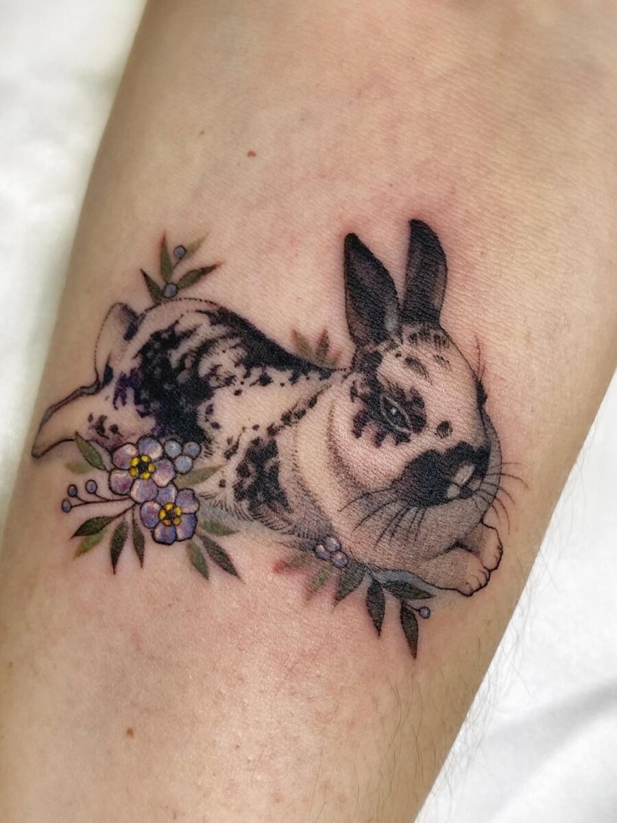 Charming rabbit tattoo with floral accents Tattoo Design