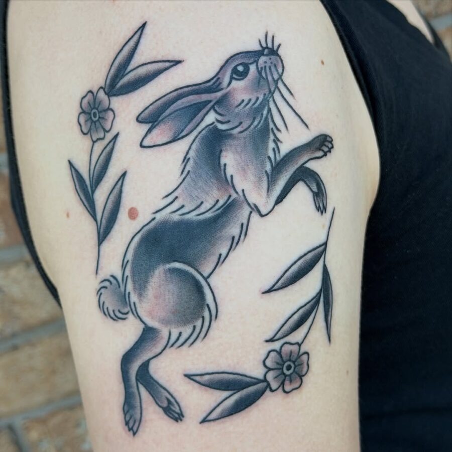 Charming rabbit tattoo with floral accents Tattoo Design