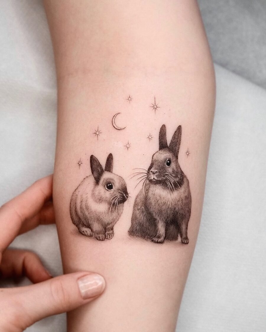 Charming rabbits surrounded by stars and moon Tattoo Design