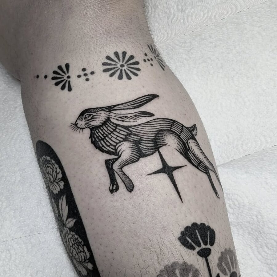 Elegant leaping rabbit tattoo in black ink Tattoo Design