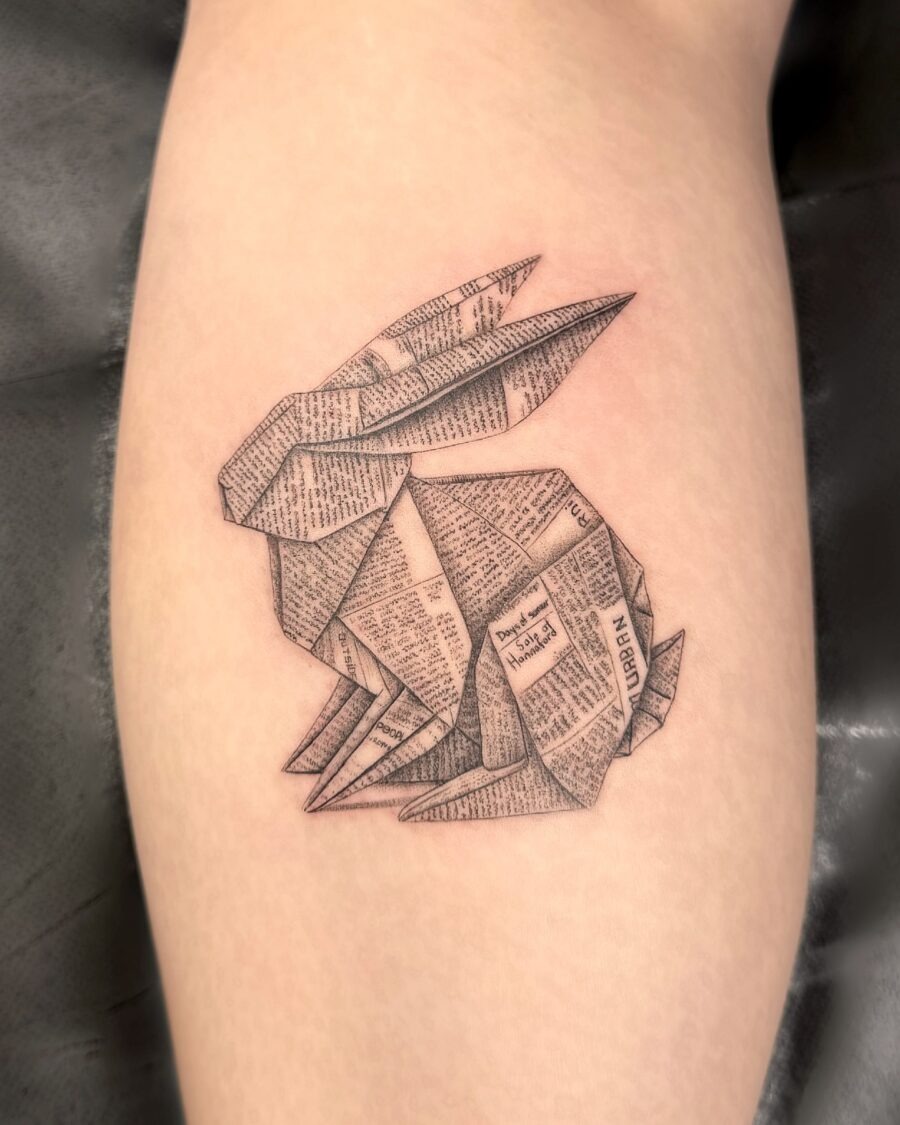 Elegant origami rabbit tattoo in newspaper style Tattoo Design