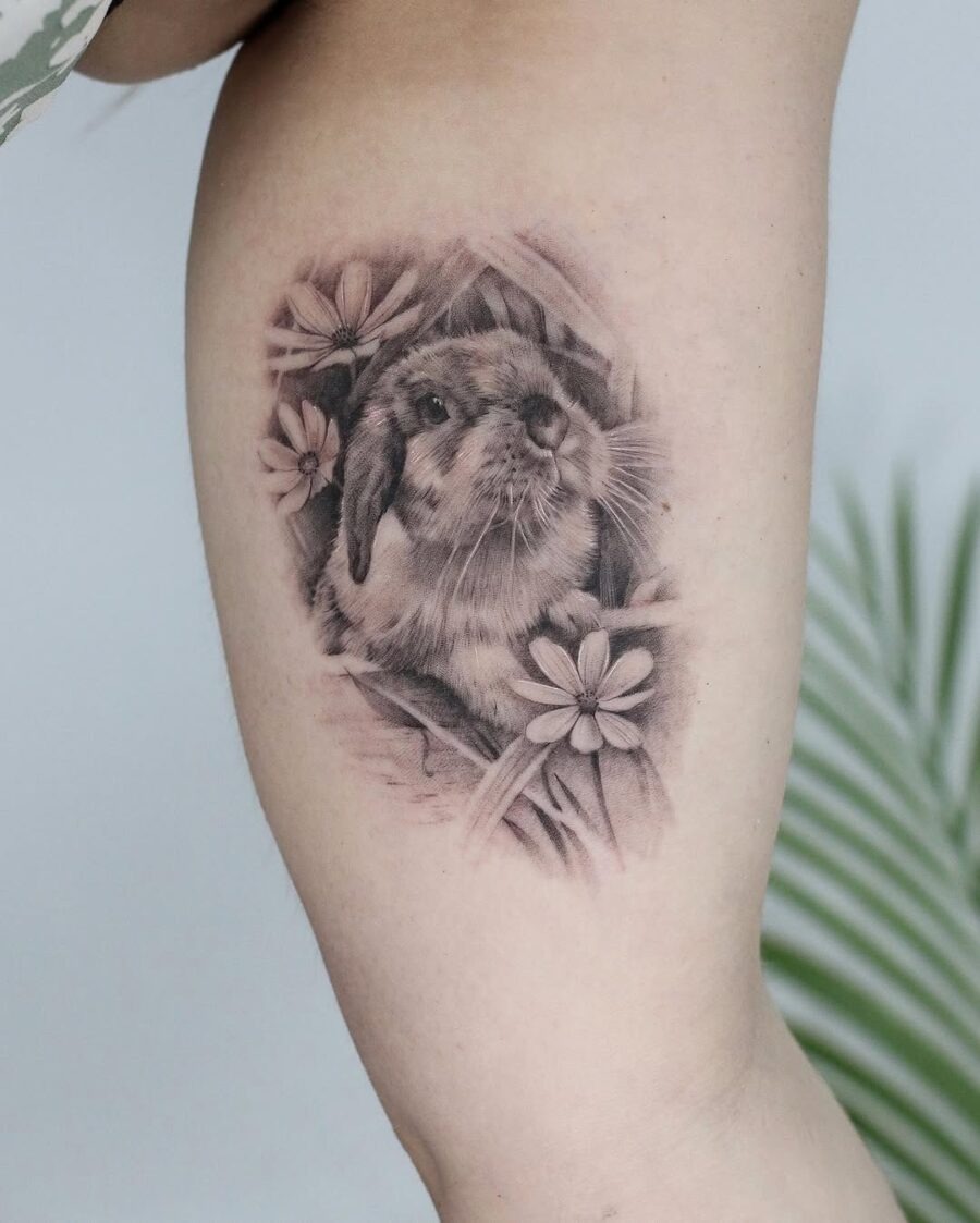 Elegant rabbit tattoo showcasing floral elements Tattoo Design