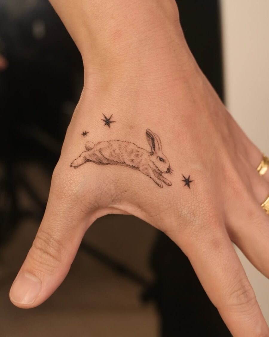 Whimsical rabbit tattoo with celestial accents Tattoo Design