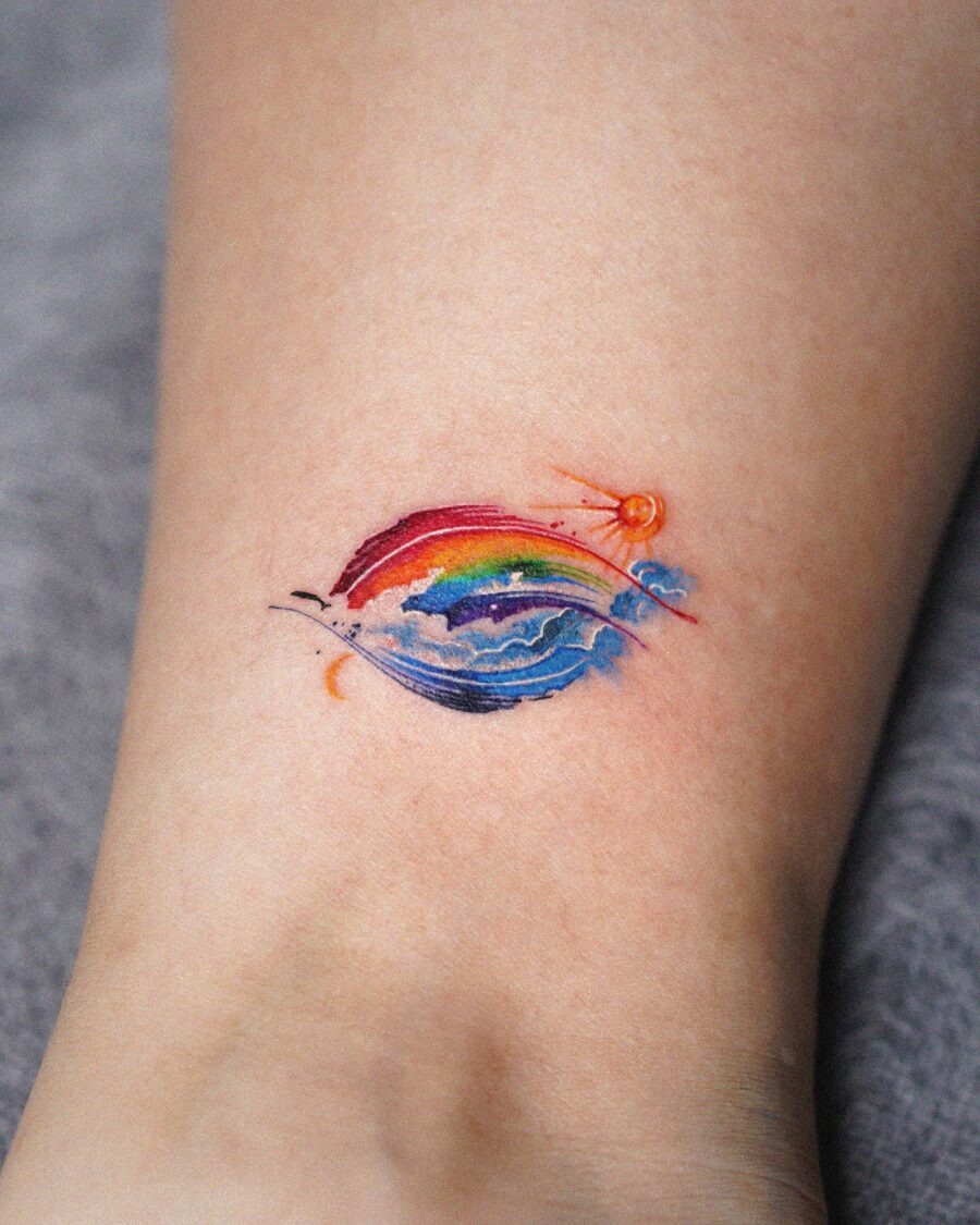 A vibrant rainbow baby tattoo with sun motif Tattoo Design
