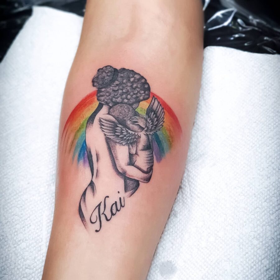 Charming rainbow baby tattoo with playful elements Tattoo Design