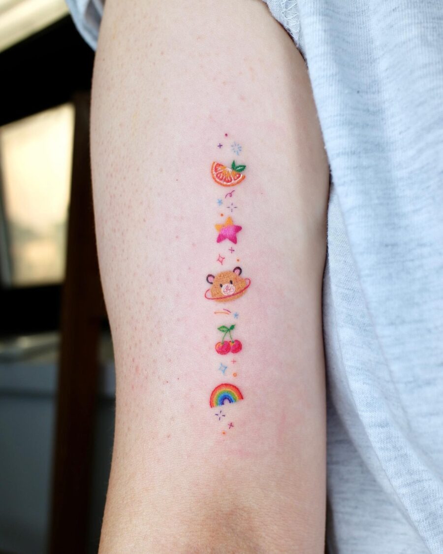 Charming rainbow baby tattoo with playful elements Tattoo Design