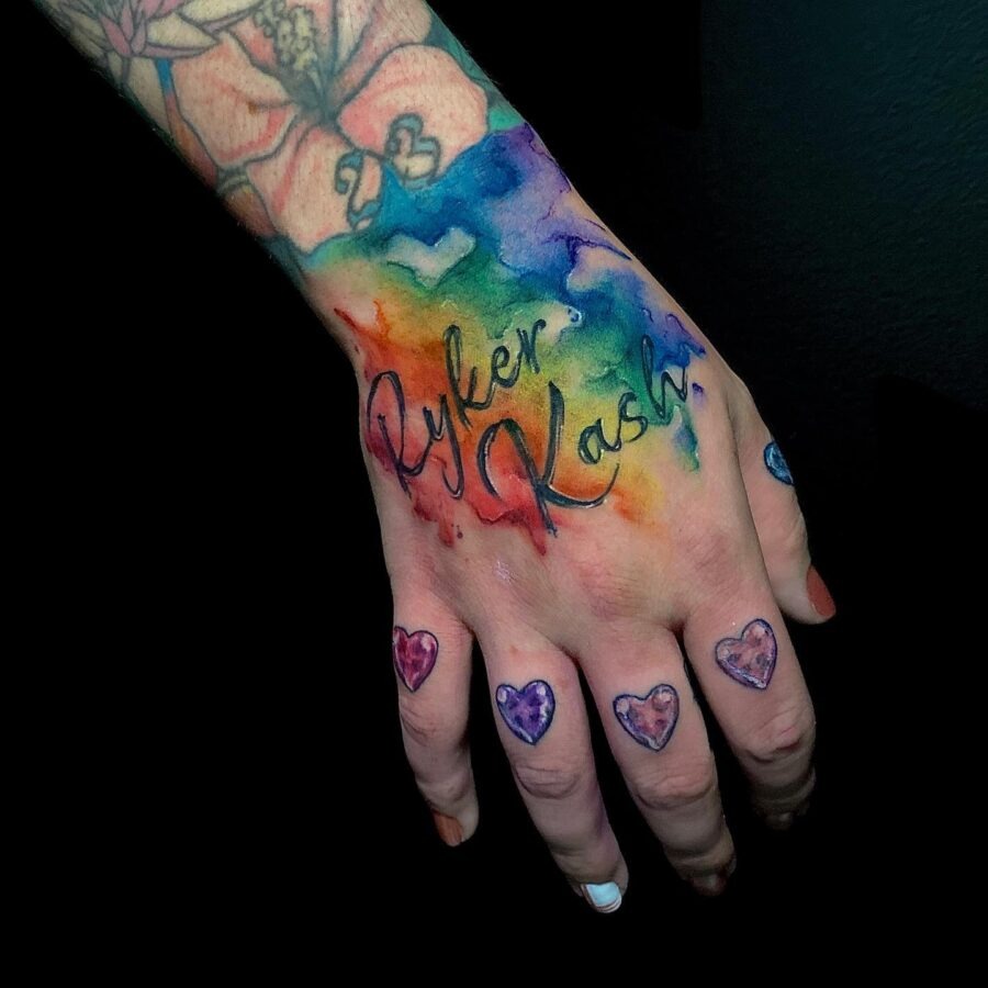 Vibrant rainbow baby tattoo on a hand. Tattoo Design