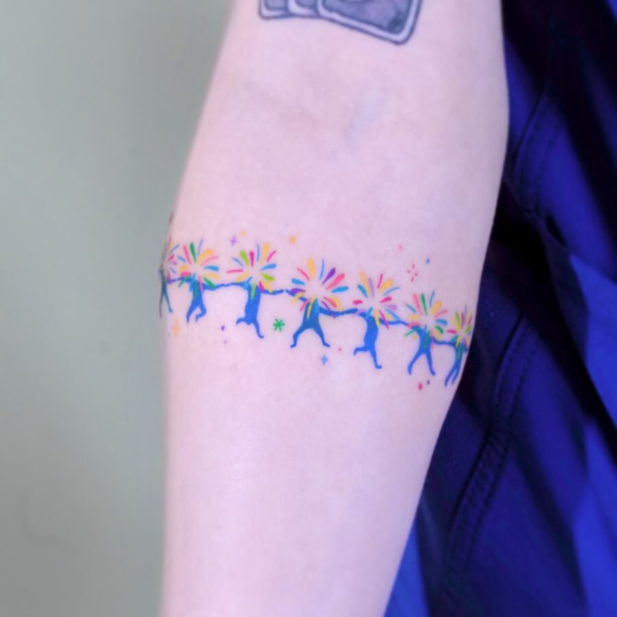 Vibrant rainbow baby tattoo on arm skin Tattoo Design