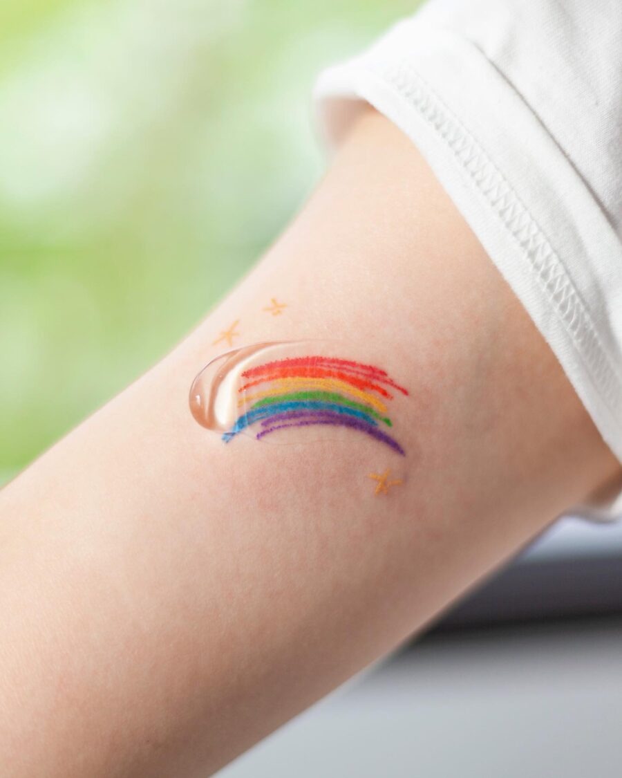 Vibrant Rainbow Baby Tattoo on Child's Arm Tattoo Design