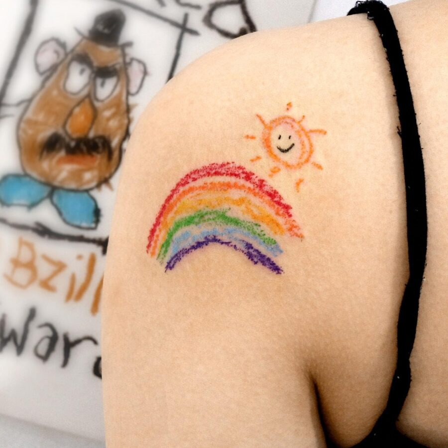 Vibrant rainbow baby tattoo on relaxed arm Tattoo Design