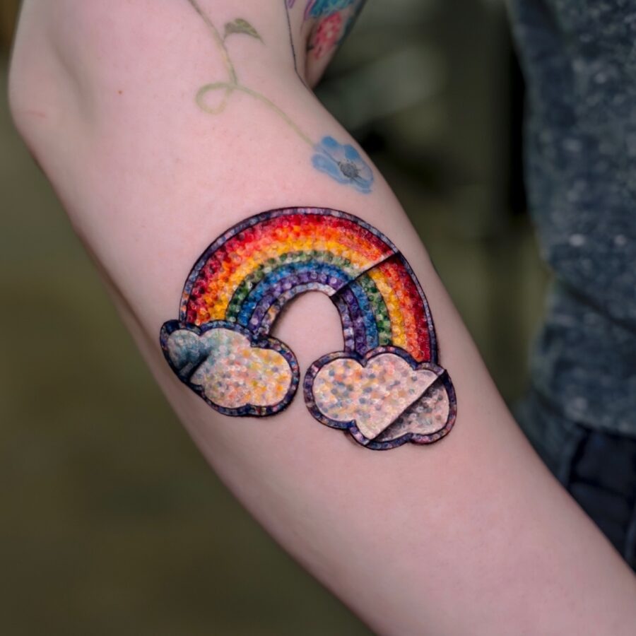 Vibrant rainbow baby tattoo with clouds Tattoo Design