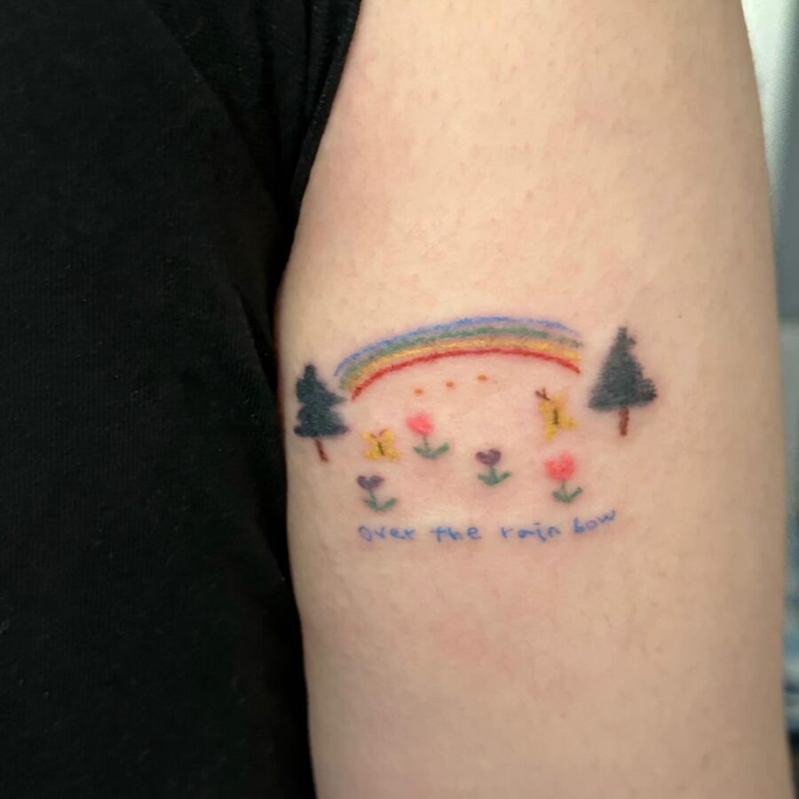 Vibrant rainbow baby tattoo with playful elements Tattoo Design