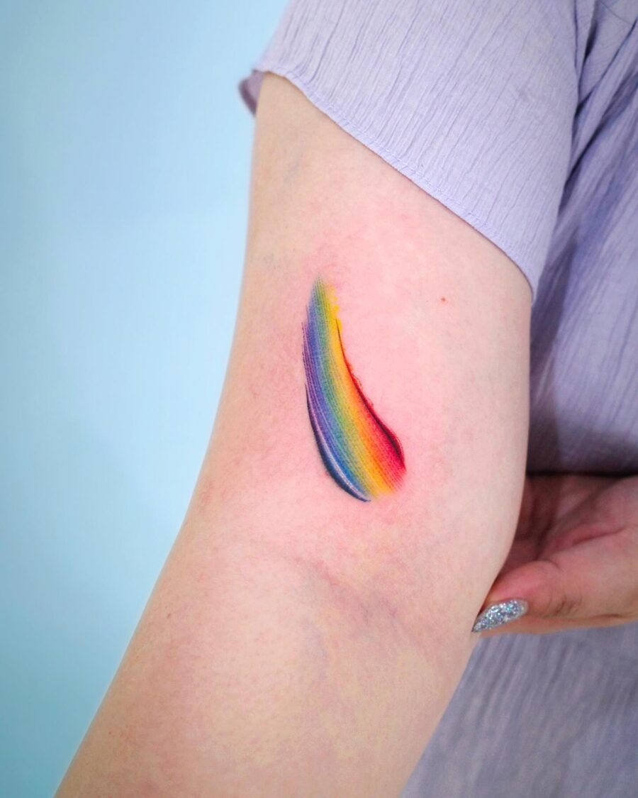 Vibrant small rainbow tattoo on forearm Tattoo Design