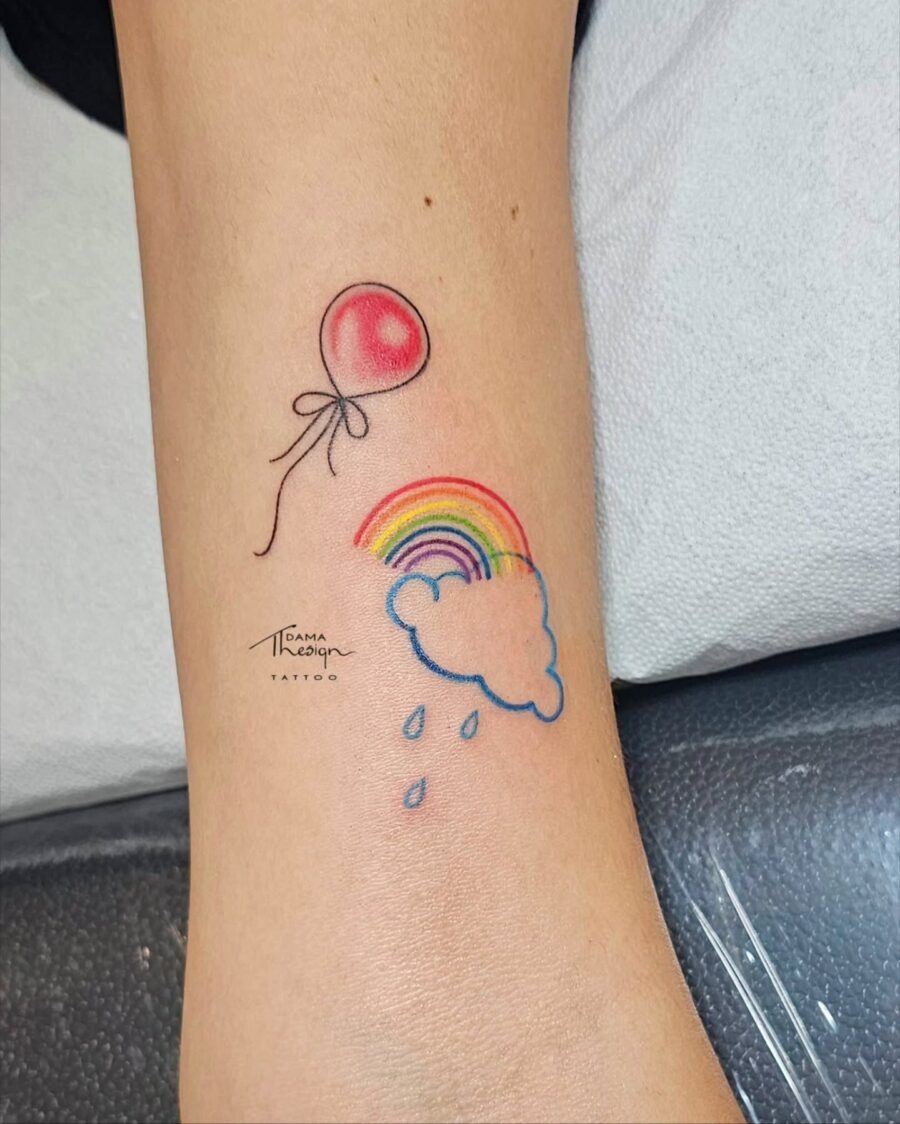 Whimsical rainbow baby tattoo with balloon Tattoo Design