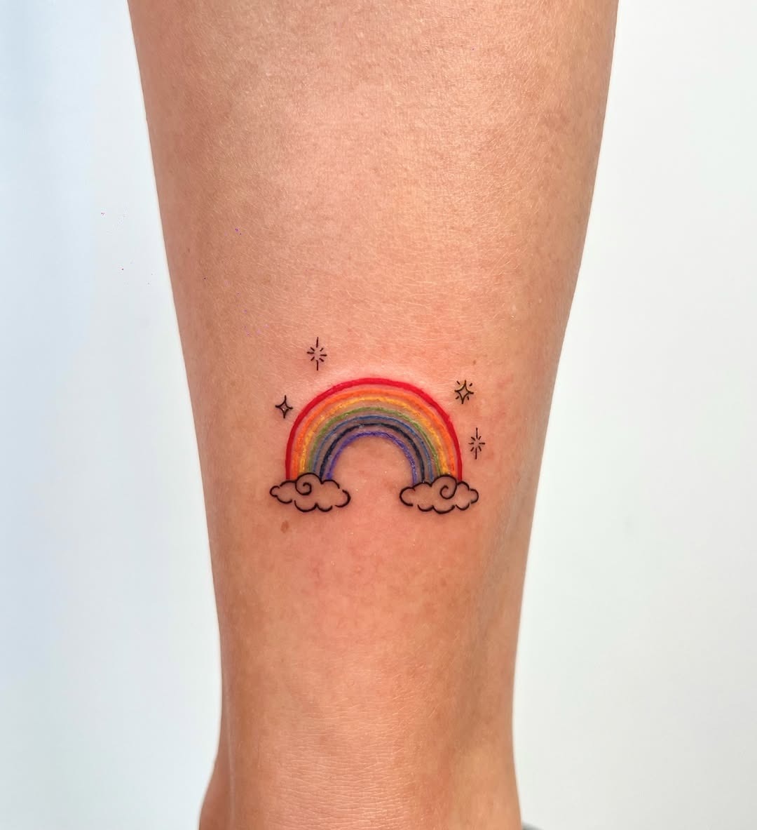 Charming Rainbow Tattoo with Cloud Elements Tattoo Design