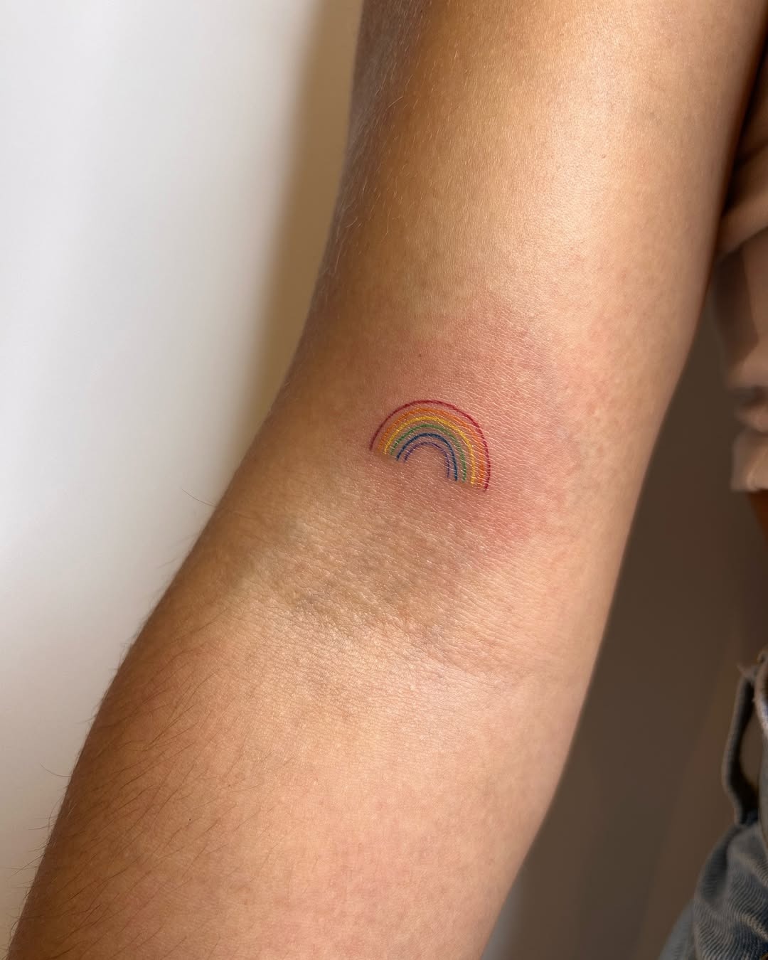 Charming Small Rainbow Tattoo on Arm Tattoo Design