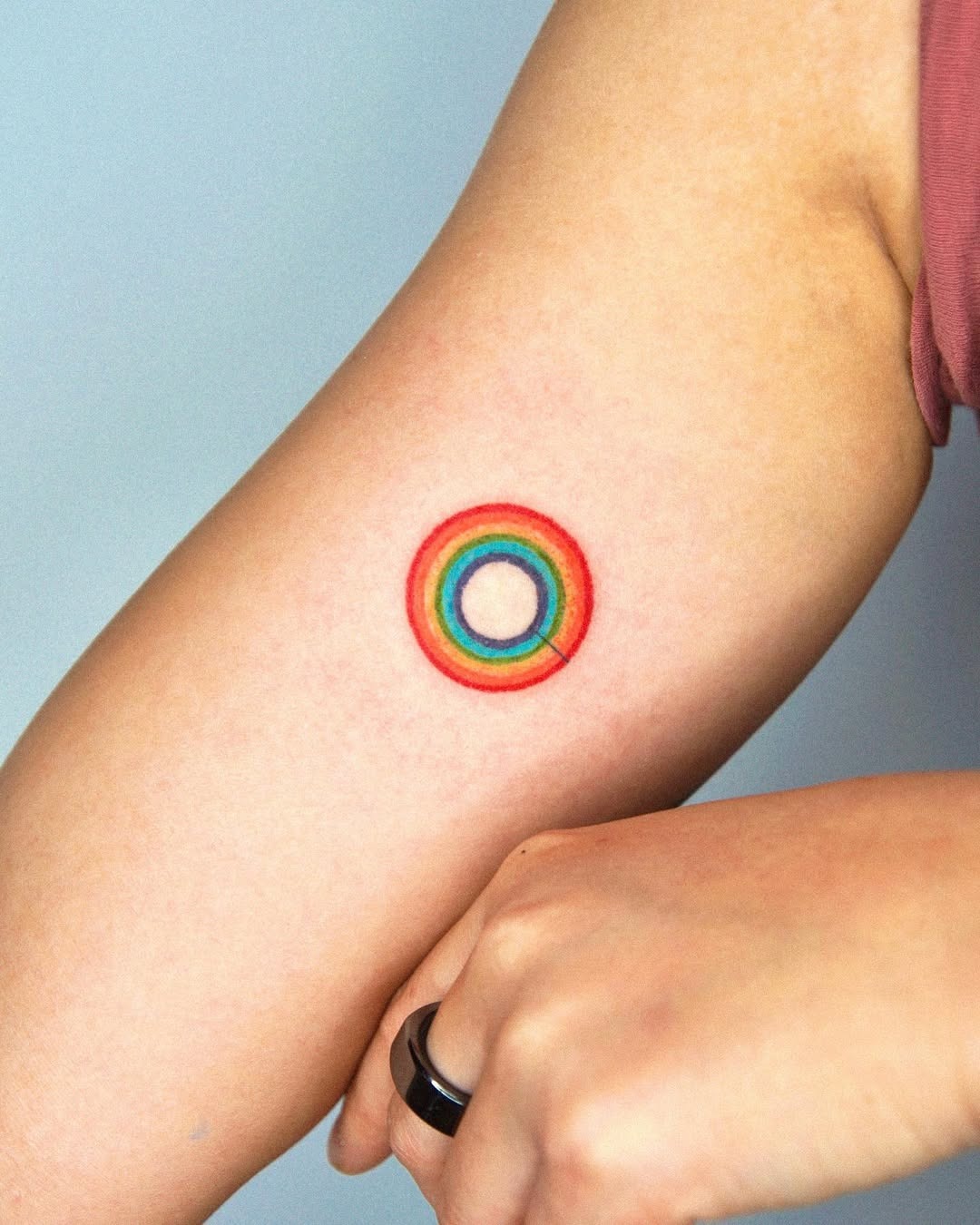 Vibrant Rainbow Circle Tattoo on Arm Tattoo Design