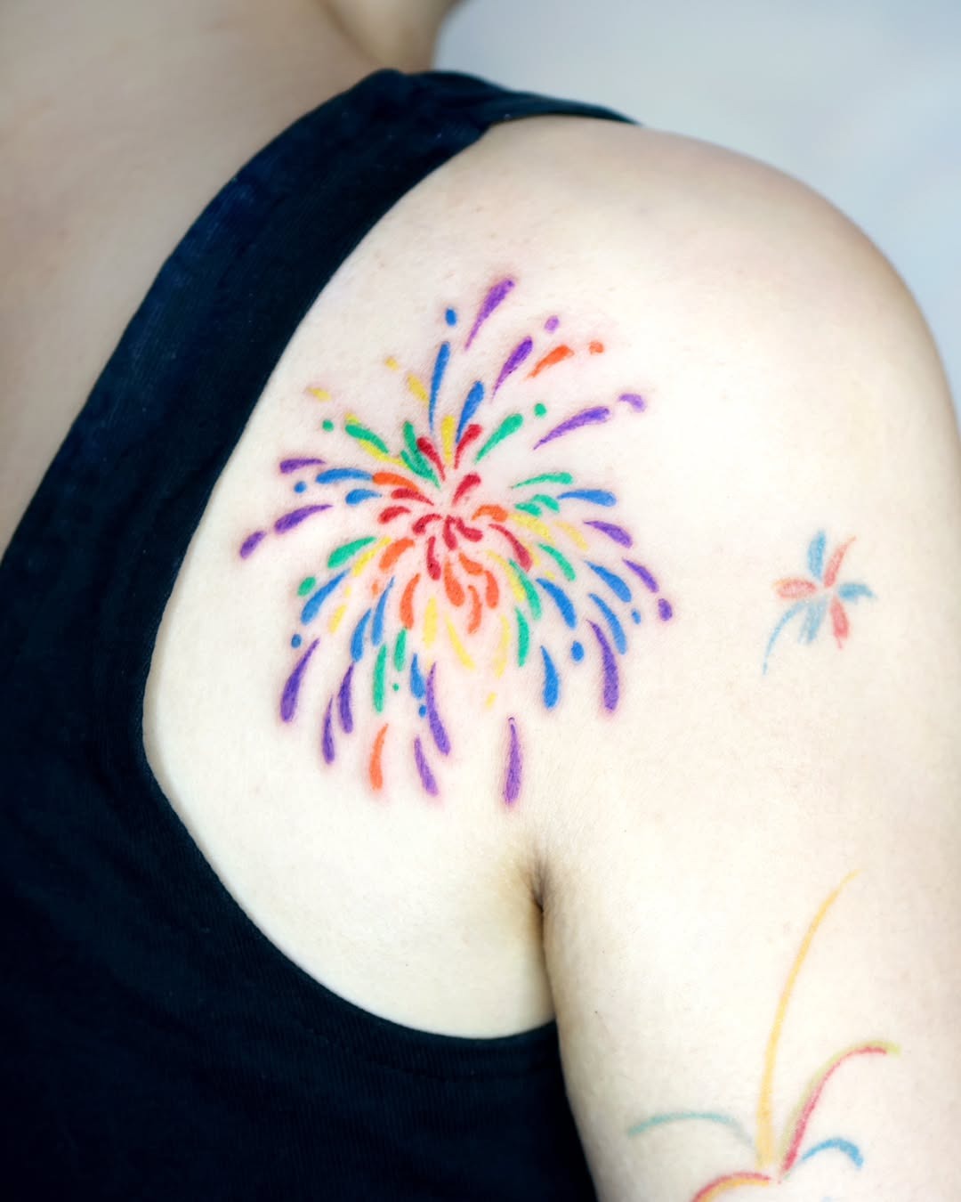 Vibrant Rainbow Explosion Tattoo on Shoulder Tattoo Design