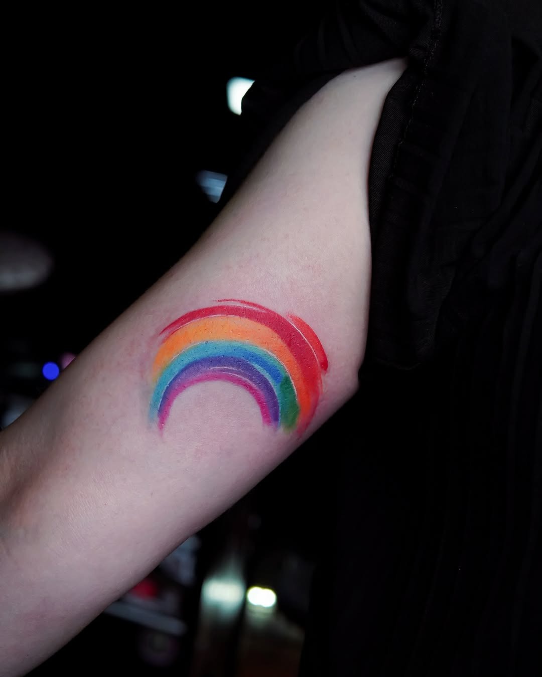 Vibrant Rainbow Tattoo on Arm Tattoo Design