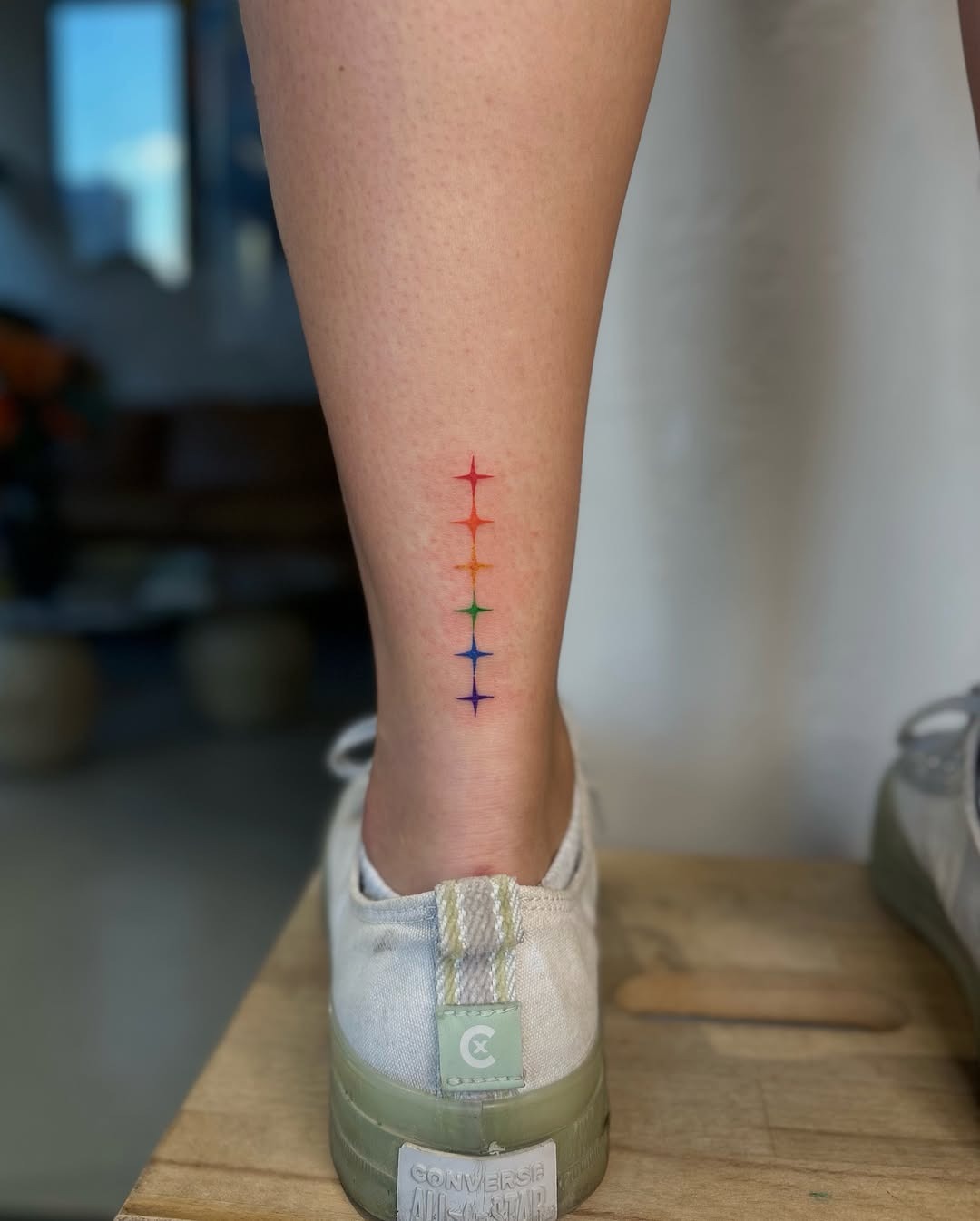 Vibrant Rainbow Tattoo on Leg Tattoo Design
