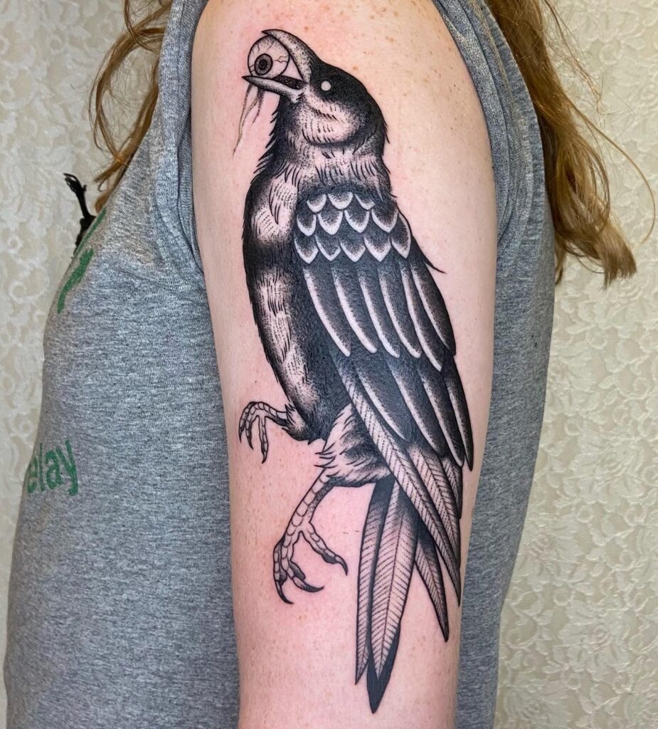 Raven Holding an Eyeball Tattoo Design