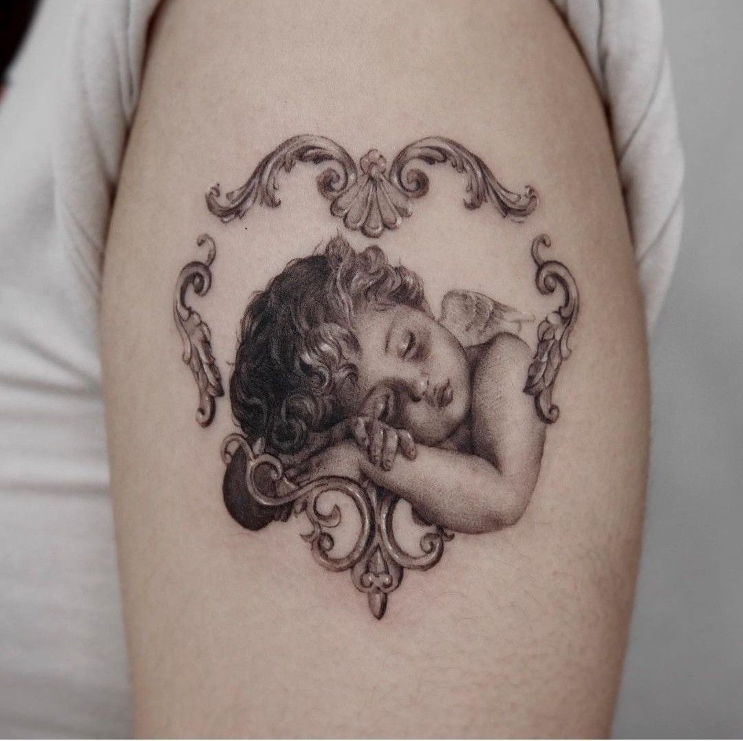 Sleeping Cherub Frame in Black and grey Tattoo Design