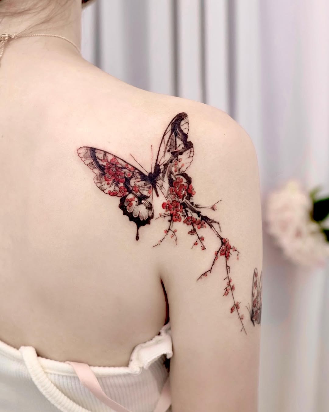 Elegant butterfly tattoo with floral elements Tattoo Design