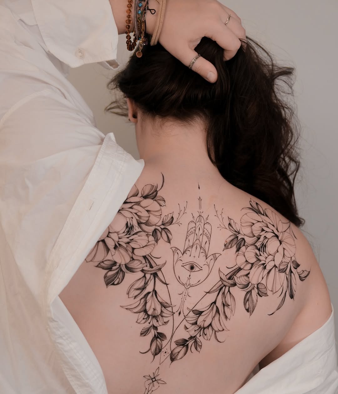 Intricate floral hamsa with mystical eye design Tattoo Design