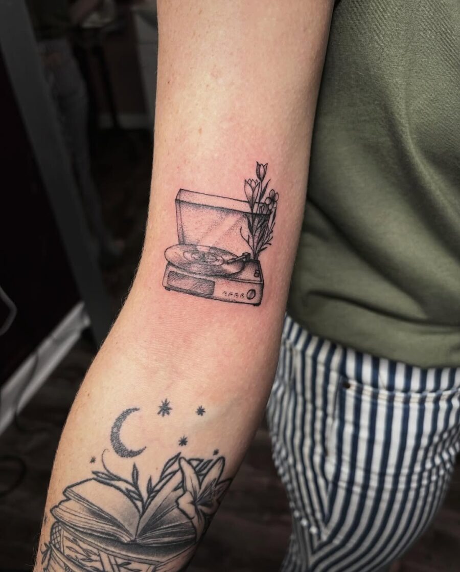 Charming record player tattoo with floral accents Tattoo Design