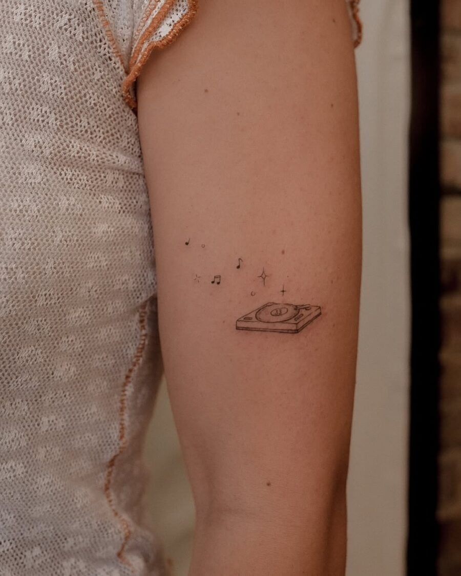 Charming record player tattoo with musical notes Tattoo Design