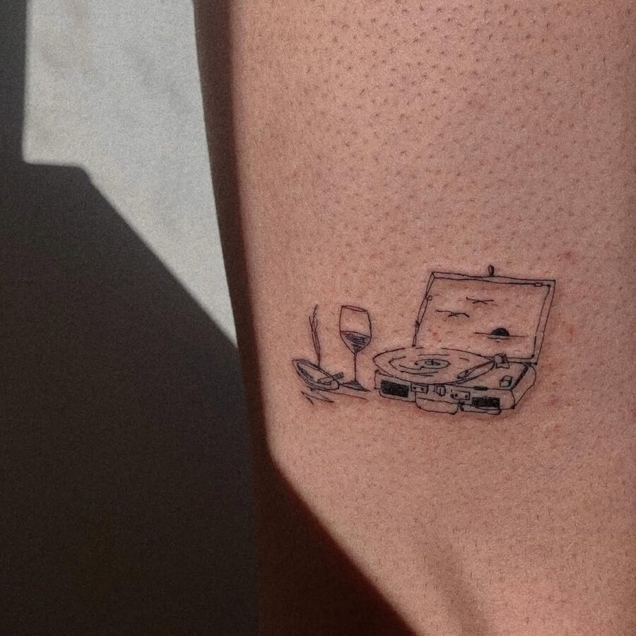 Creative record player tattoo with wine glass Tattoo Design