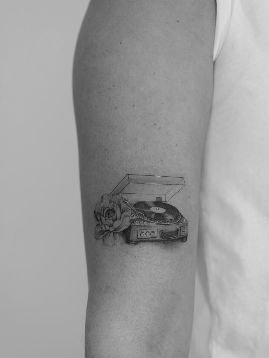 Elegant record player tattoo with floral elements Tattoo Design