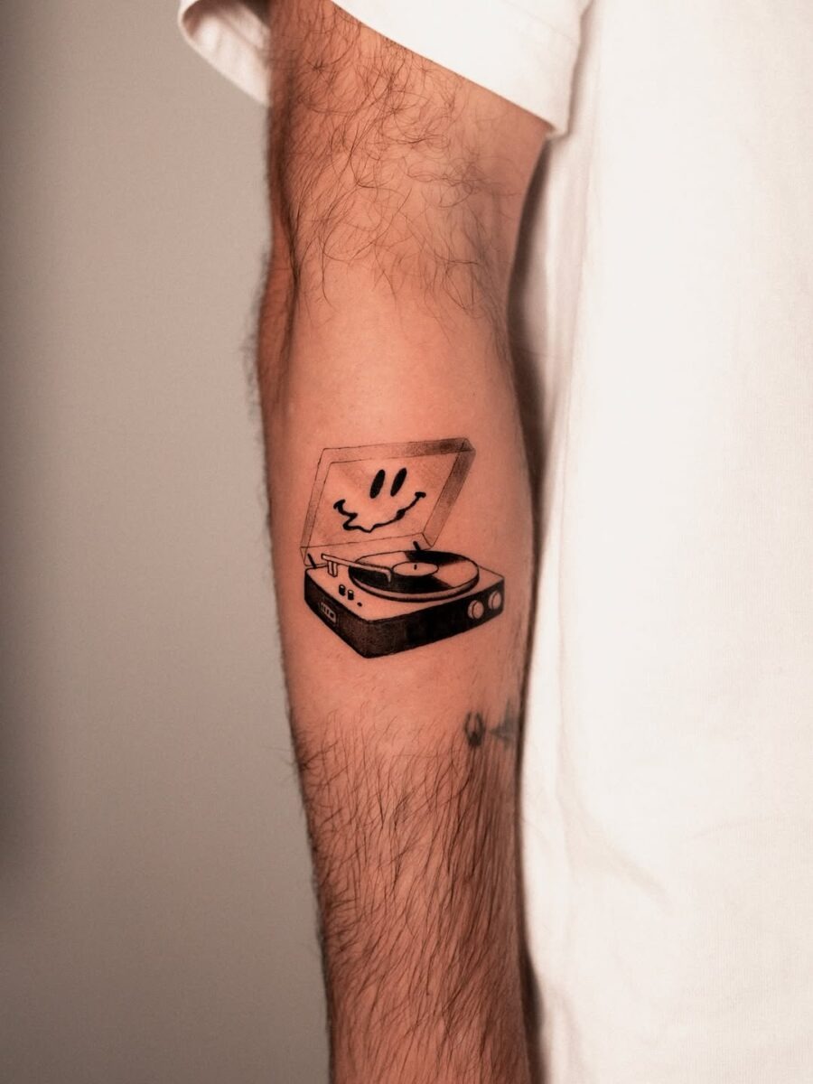 Playful record player tattoo with a smiley face Tattoo Design