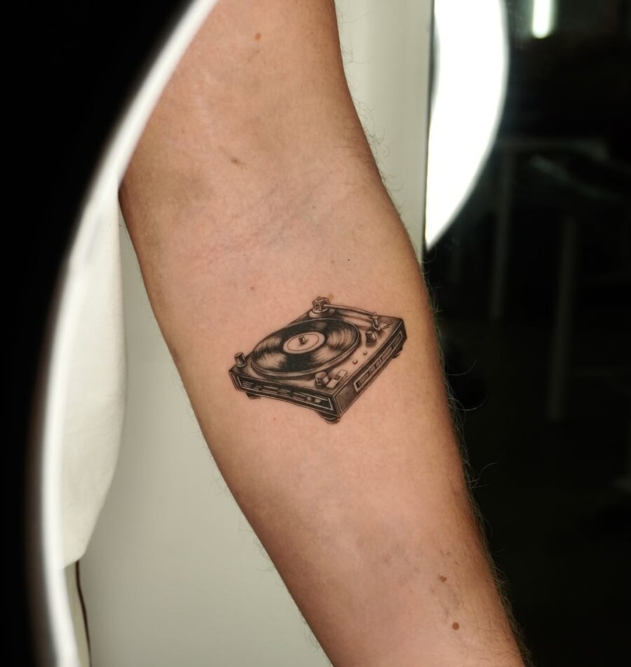 Sleek record player tattoo on forearm Tattoo Design
