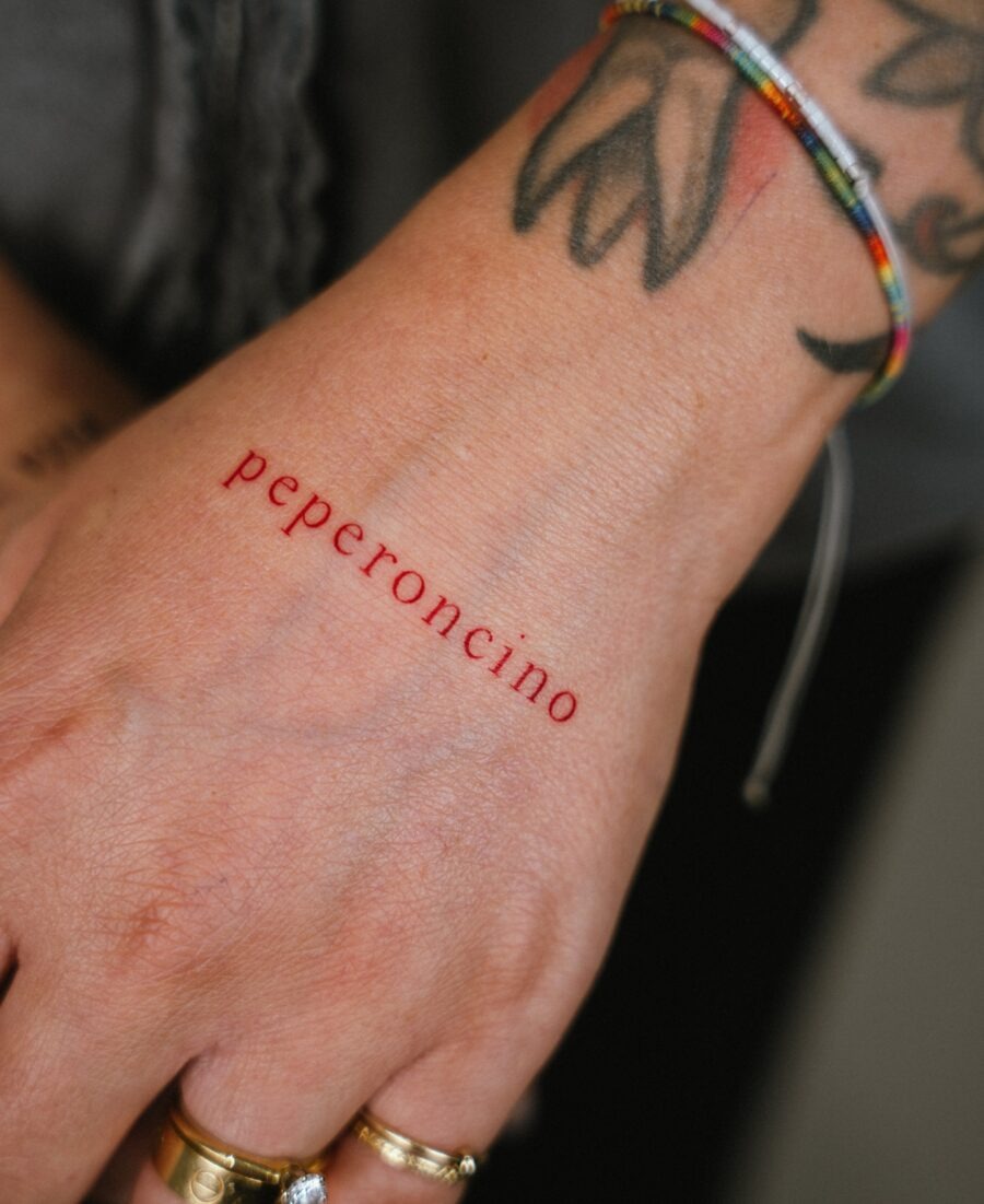 Bold red ink tattoo featuring unique lighter design Tattoo Design