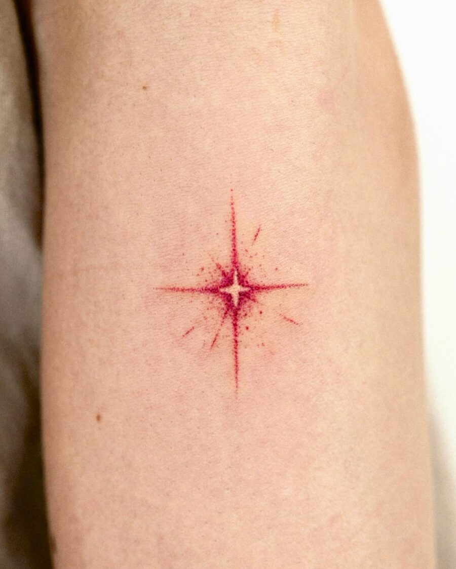 Bold red star tattoo on soft skin Tattoo Design