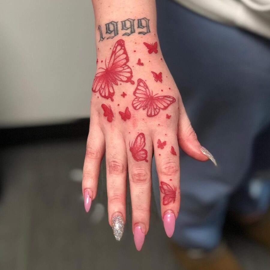 Delicate red ink flower tattoo on palm Tattoo Design