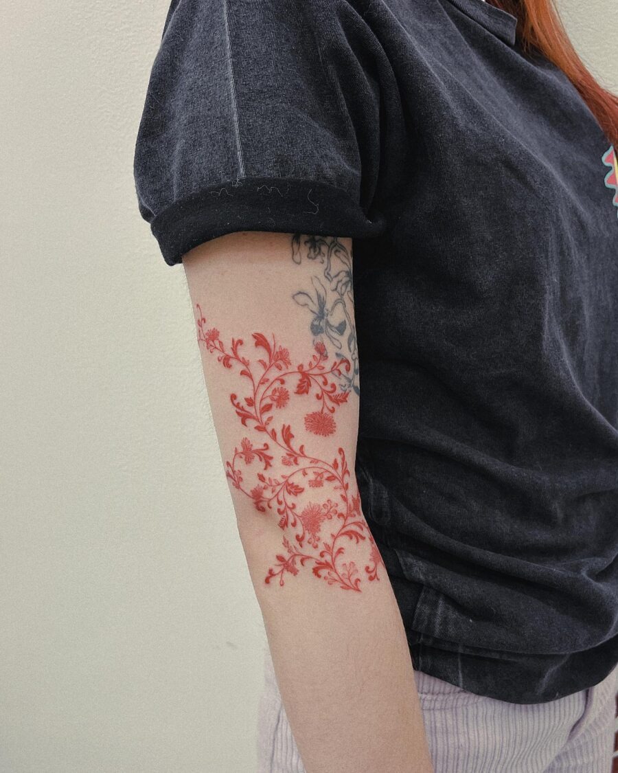 Elegant red flower tattoos with intricate designs Tattoo Design