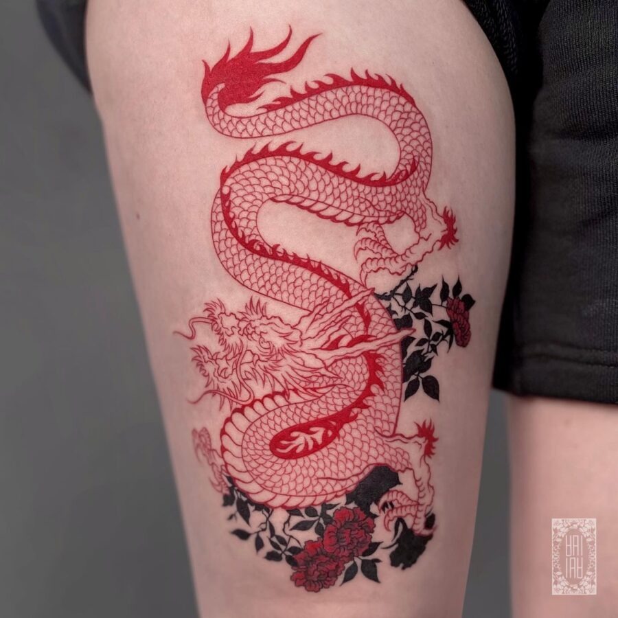 Intricate red floral design tattoo on arm Tattoo Design