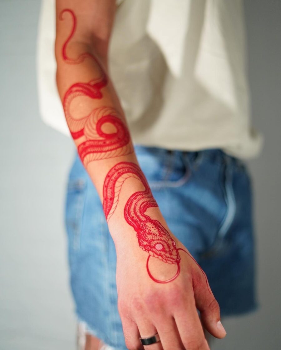 Intricate red ink dragon tattoo on forearm Tattoo Design
